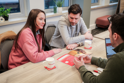 Christine piaras with aaron looking at brochure 900x600px